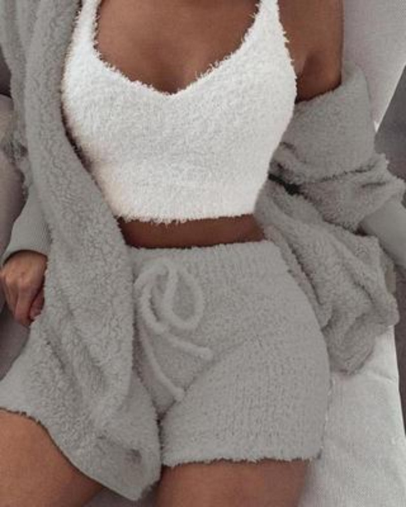 Person wearing a white textured top and gray shorts with a matching robe.