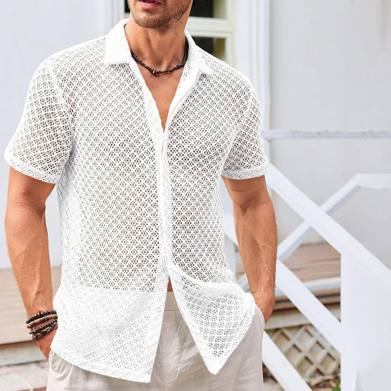 Man wearing a white lace shirt with a blurred background